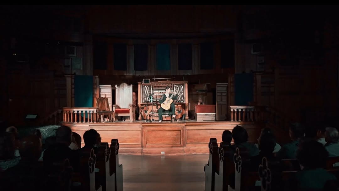 Laurel Harned performing classical guitar on stage